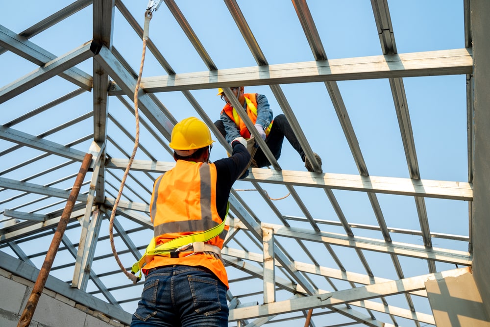 builder working on a new commercial roof
